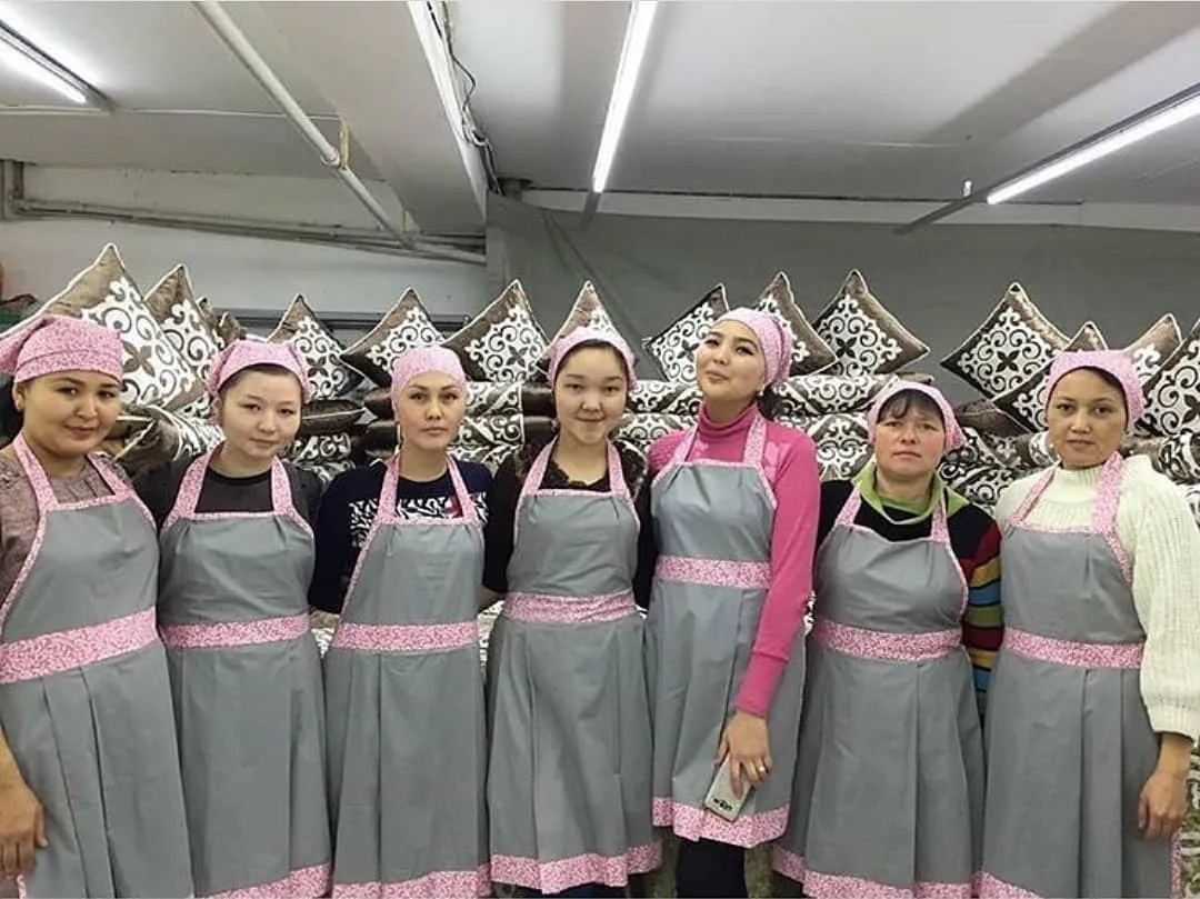 The Xan Kyzy team in branded aprons at the showroom